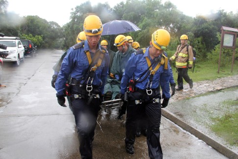 The Belgian runner is taken to hospital after slipping off the path. It took rescuers four hours to reach and free him. Photo: SCMP Pictures